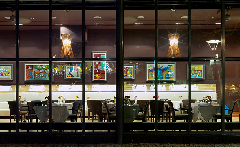 Floor-to-ceiling windows looking into The River Grille restaurant